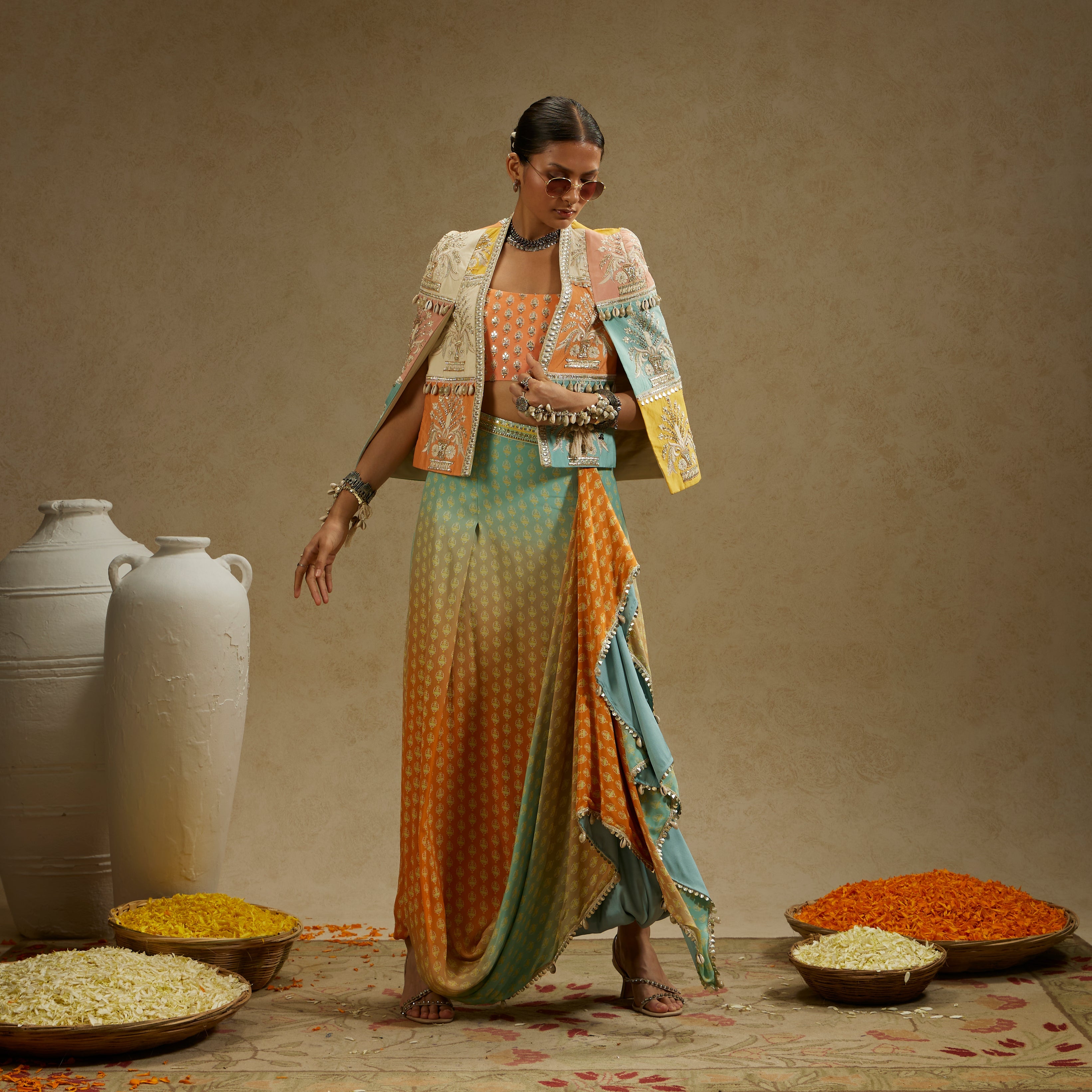 Colour Blocked Patchwork Cape Jacket Paired With An Embellished Bustier And An Ombre Printed Draped Skirt