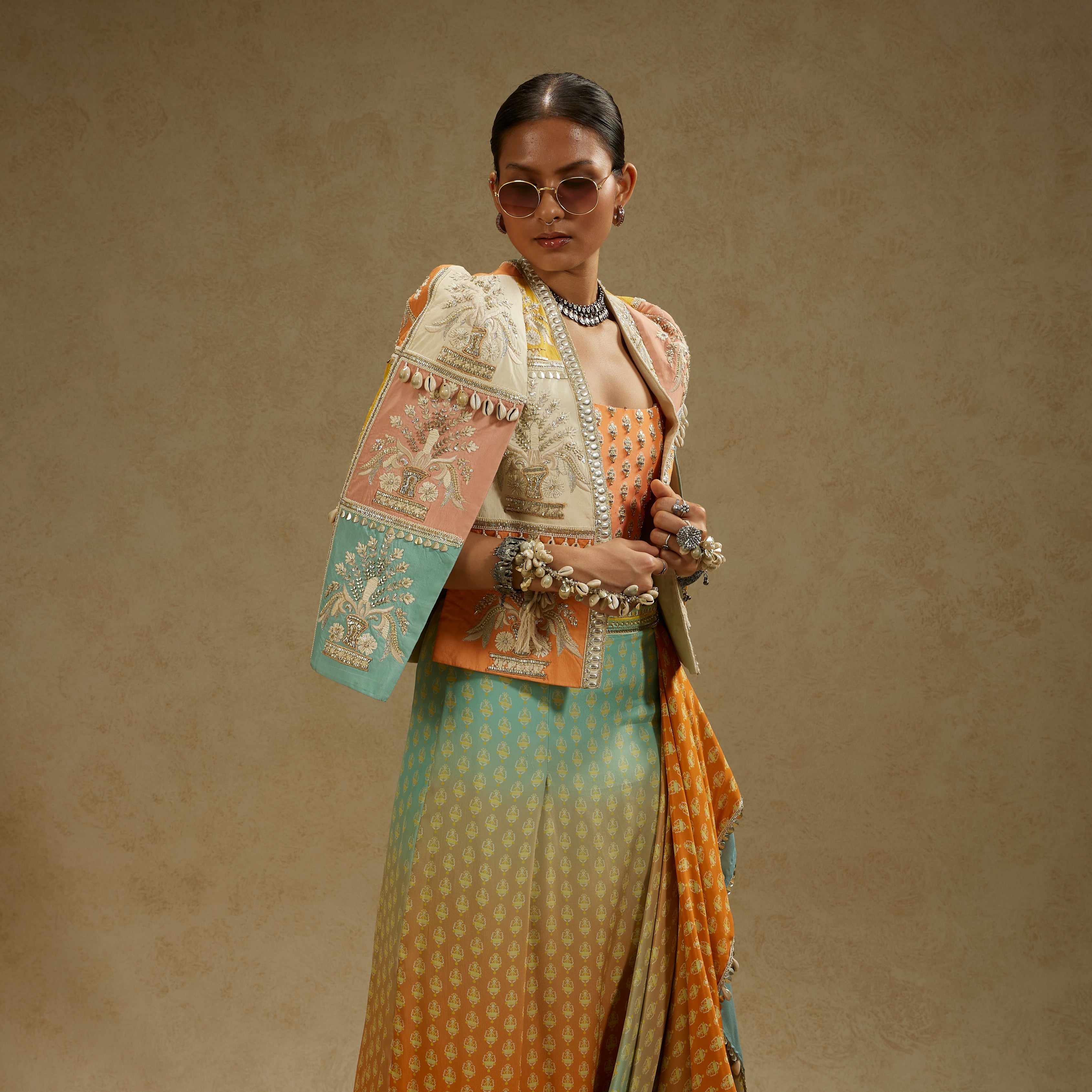 Colour Blocked Patchwork Cape Jacket Paired With An Embellished Bustier And An Ombre Printed Draped Skirt